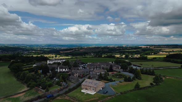 Ariel footage of village houses in the  town of Emley Huddersfield West Yorkshire. Rural Drone Scene