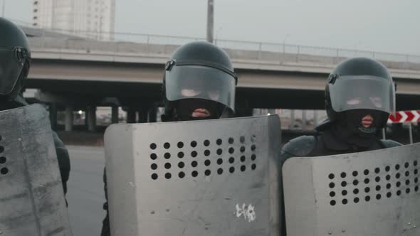 Riot Police with Shields Blocking Street