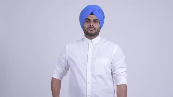 Young Bearded Indian Sikh Man Wearing Turban with Arms Crossed