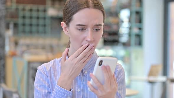 Portrait of Loss on Smartphone By Young Businesswoman