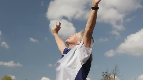 Active Mature Senior Woman Doing Sports Cool Down Take Deep Breath Hands Up