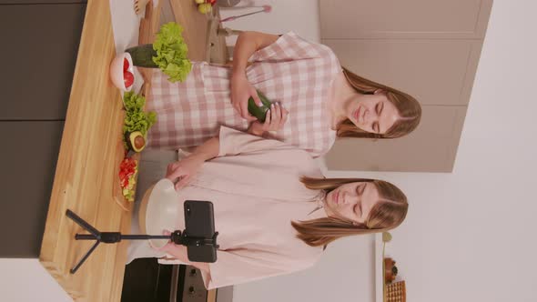 Vertical Shot of Twins Recording Cooking Video