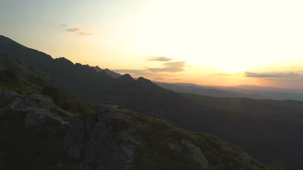 Winner Man on Peak of Rocky Mountain Hiking at Sunset