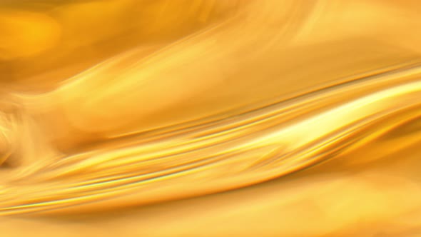 Super Slow Motion Abstract Shot of Waving Golden Oil Background at 1000Fps