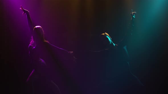 Silhouette of Dancing Couple Will Emerge From Darkness and Smoke