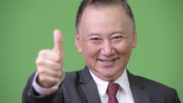 Mature Japanese Businessman Giving Thumbs Up