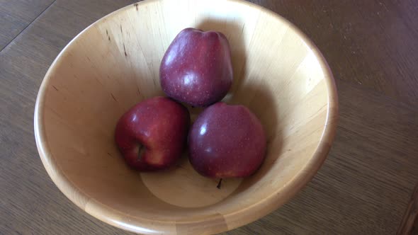 Fruits in bowl. Ripe apple in the hand of a small child