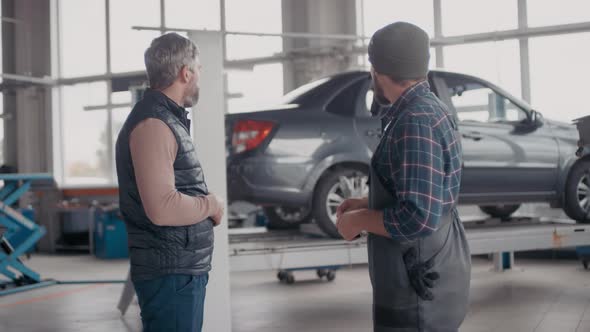 Auto Mechanic Giving Car Keys to Client