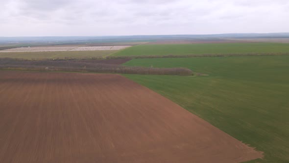 Aerial Drone Footage Approaching Farm Fields in Countryside