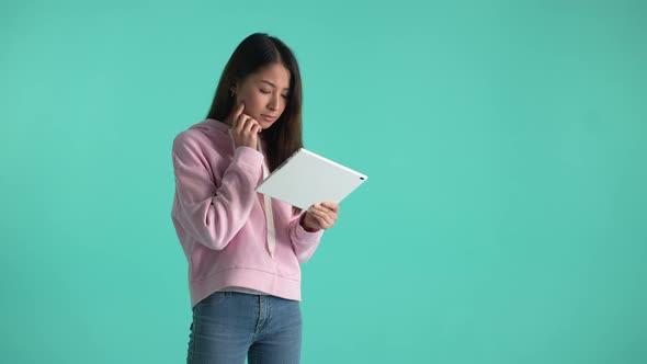 Asian Girl Using Tablet Isolated on Background