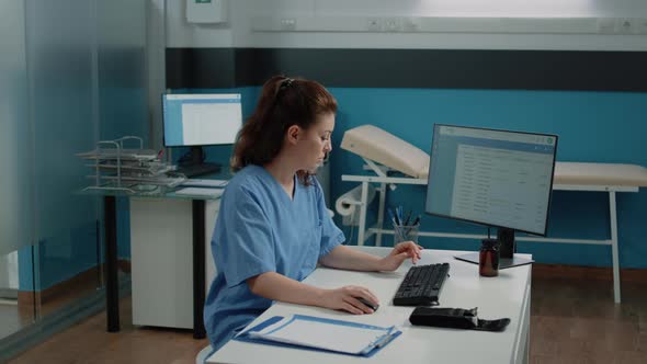 Portrait of Nurse Using Computer for Appointments with Patient