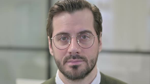 Close Up of Face of Young Businessman Looking at the Camera