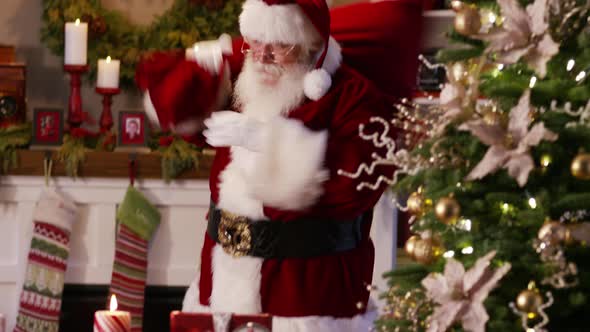 Santa Claus waves and says "Merry Christmas"