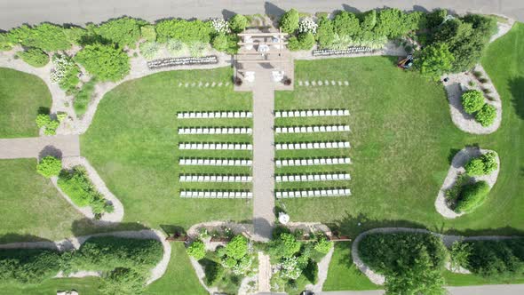 Drone shot coming down on a wedding ceremony setup in a courtyard garden