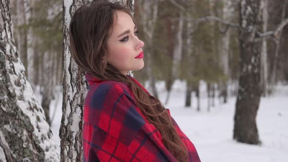 Woman with Red Lips in Winter Forest