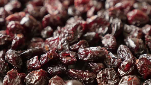 Dehydrated cranberries on pile slow tilt 4K 2160p 30fps UltraHD footage - Heap of red dried berries 