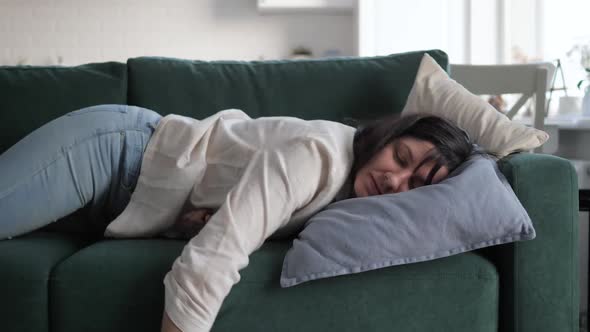 Tired Weary Woman Falls On Sofa With Pillow Falling Asleep