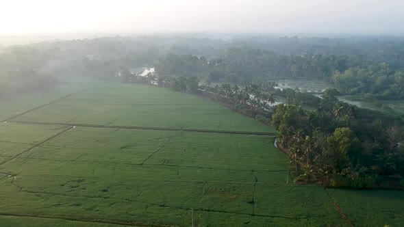 Sunrise in a Asian paddy field village,sky,Sun beam reflection ,River,Aerial Shot,irrigation,Mist,Ma