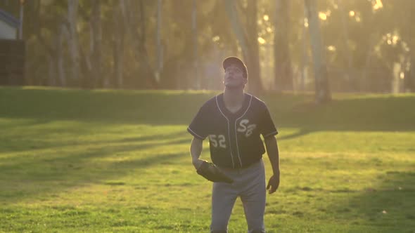 A young man playing catch with a baseball.