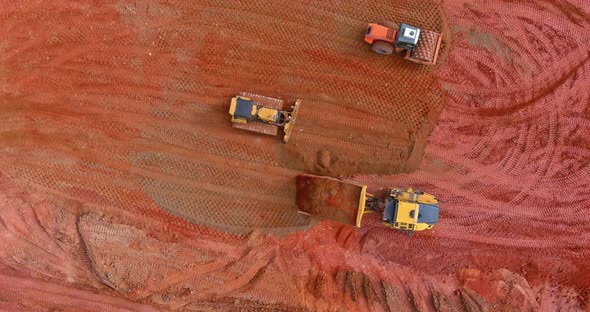 Aerial View of Industrial Crawler Excavator in the Process of Work Digs Out the Earth and Pours It