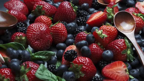 Cooking Raspberry and Blueberry Berry Jam. Rotation on a Black Background