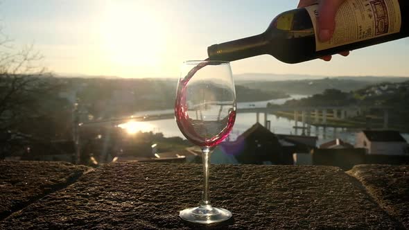 Pouring Red Wine From a Bottle Into the Glass