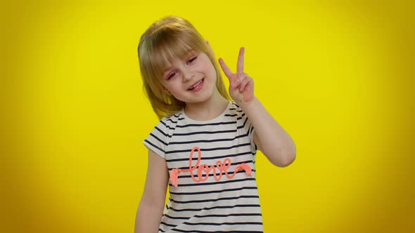 Funny Blonde Smiling Kid Child Showing Victory Sign Hoping for Success and Win Doing Peace Gesture