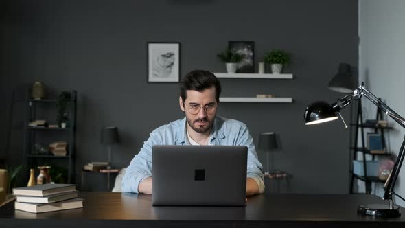 Young man freelancer student using laptop studying online working from home in internet