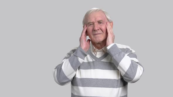 Senior Man with Headache, Grey Background.