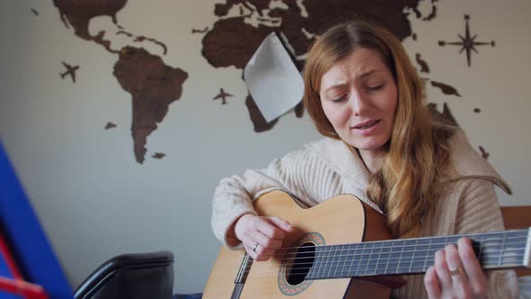 Woman Singing With Guitar