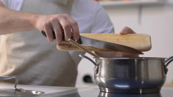 Man Adding Cropped Bell Pepper Into Pan and Stirring, Cooking Vegetable Stew