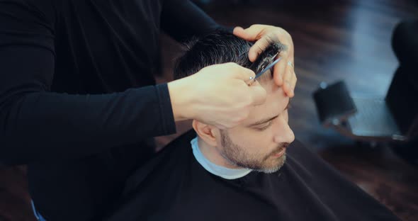 Hairdresser Cuts Quiff on a Man with Gray Hair