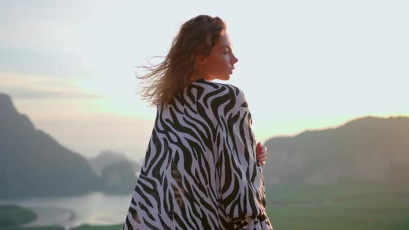 Woman Enjoys Her Morning Sunrise on the Mountain View Point Dressed on Tunic