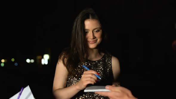 Famous Woman Signing Autographs in Fans Notebooks at Evening Party, Stars Life