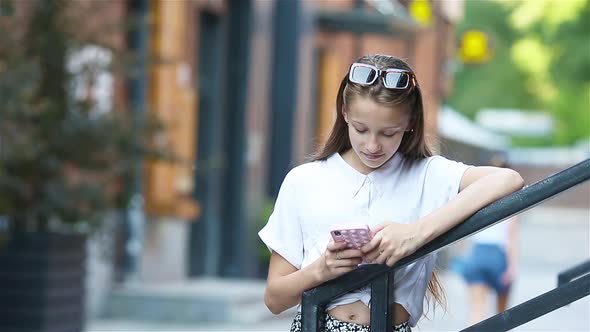 Cute Girl Outdoors with Smartphone