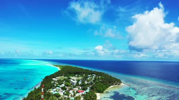 Aerial above panorama of idyllic seashore beach lifestyle by blue lagoon and white sandy background 