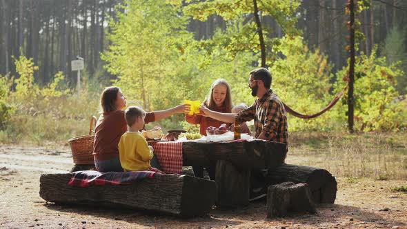 People on a Picnic at a Resting Place in a Pine Forest