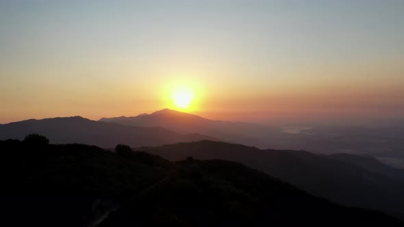 Bright Golden Sunset Over The Mountain Range. - aerial