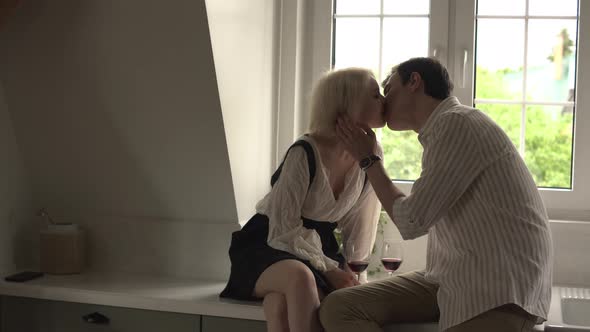 Couple Flirting and Kissing on the Windowsill