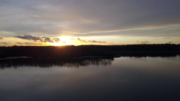 Hovering Over a Large and Big Lake at Sunset