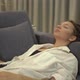 Tired Mixed Race Young Woman Lies on Grey Sofa with Pillows - VideoHive Item for Sale