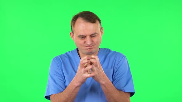 Portrait of Annoyed Medical Man Gesturing in Stress Expressing Irritation and Anger. Green Screen