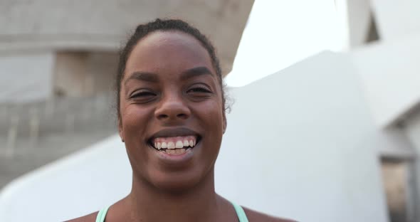 Happy african girl smiling on camera after sport workout