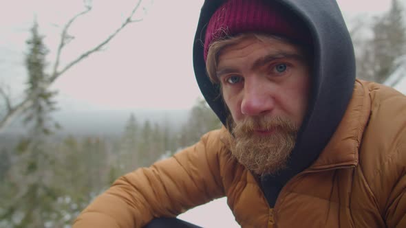 Portrait of Male Tourist in Mountains on Winter Day