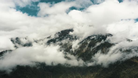 Majestic Tungurahua Volcano Peeking Through The Cloudy Atmosphere Within The Confines Of Banos In Ec