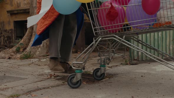 Homeless Man Out on the Streets with His Belongings in a Trolley