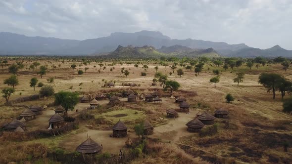 Aerial above an authentic Village With homes made from wood and straw in Uganda, East Africa