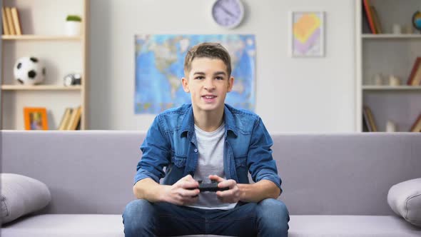 Emotional Male Teenager Winning Computer Game, Wasting Time, Procrastination