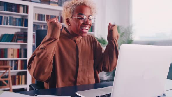 Euphoric Young African Ethnicity Woman Reading Email with Unbelievable Good News