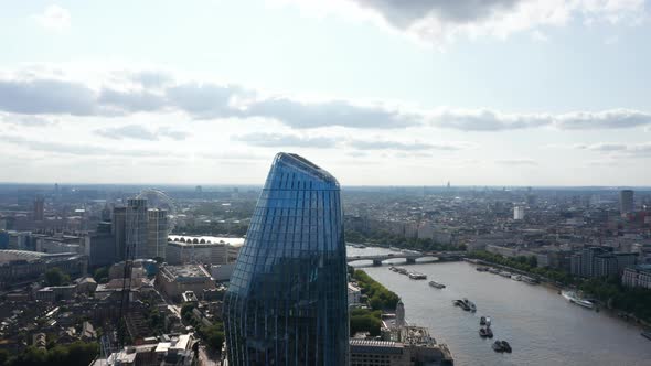 Pull Back Footage of Upper Part of One Blackfriars Tall Modern Skyscraper with Shiny Glass Facade